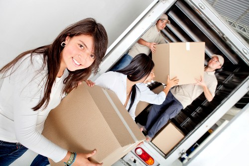 Trained removals workers handling items safely